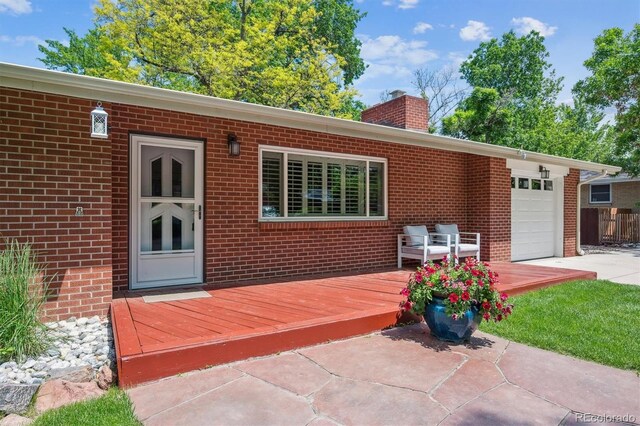 1040 Zang St, Golden, CO 80401 - wooden terrace with a garage and concrete driveway