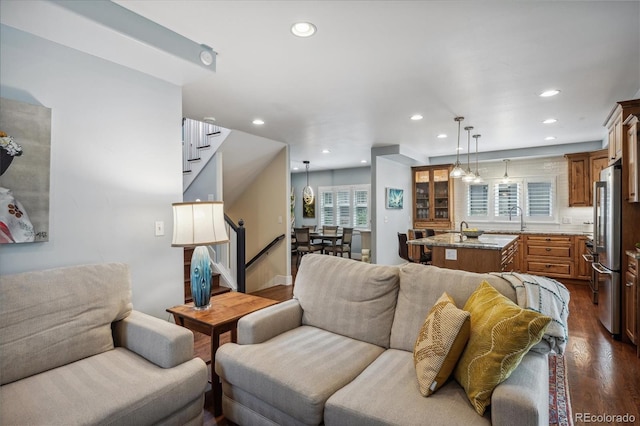 living room with dark wood-style floors, stairway, plenty of natural light, and recessed lighting