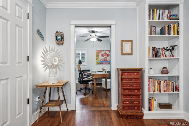 office space featuring built in features, baseboards, dark wood-style floors, ceiling fan, and crown molding