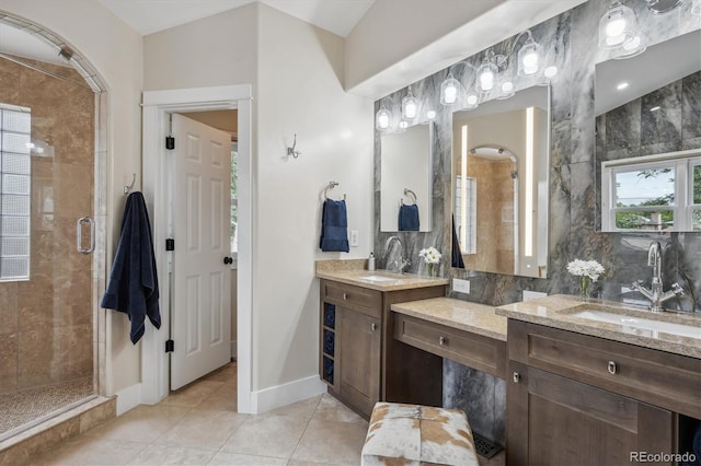 full bathroom with a stall shower, tasteful backsplash, baseboards, tile patterned floors, and vanity