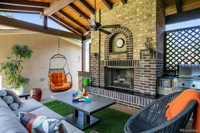 view of patio / terrace with ceiling fan, an outdoor living space with a fireplace, and area for grilling