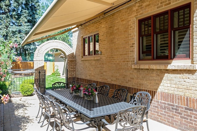 view of patio / terrace featuring fence and outdoor dining area