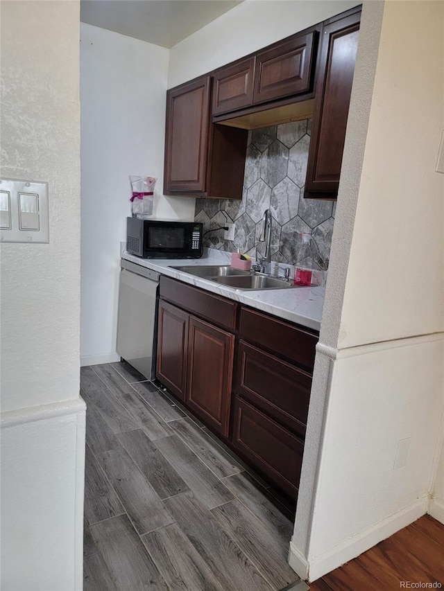 384 S Ironton St Unit 407, Aurora, CO 80012 - kitchen featuring dishwasher, black microwave, a sink, light countertops, and decorative backsplash
