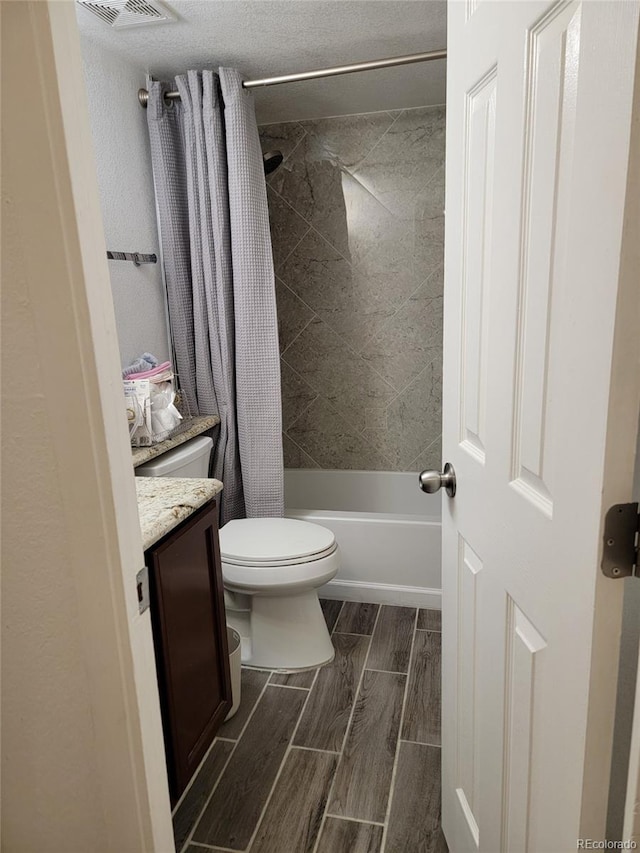 384 S Ironton St Unit 407, Aurora, CO 80012 - full bath featuring vanity, toilet, shower / tub combo, and wood tiled floors