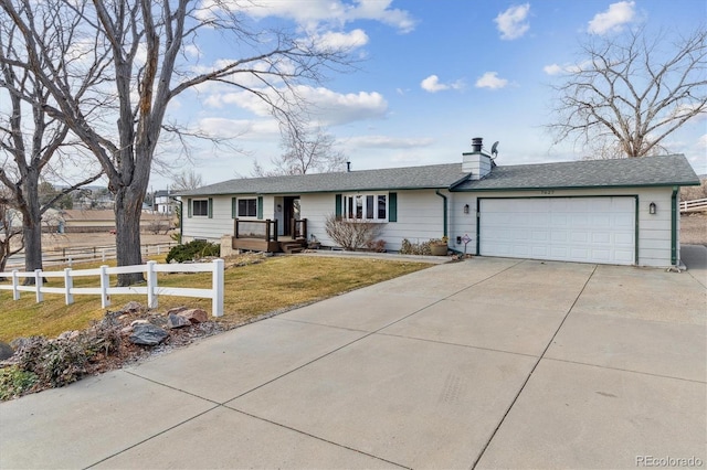 single story home featuring a garage and a front lawn