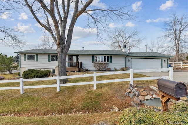 ranch-style home with a garage and a front lawn