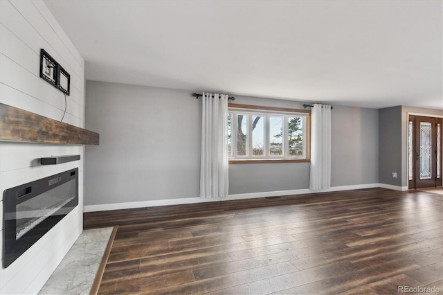 unfurnished living room featuring dark hardwood / wood-style floors