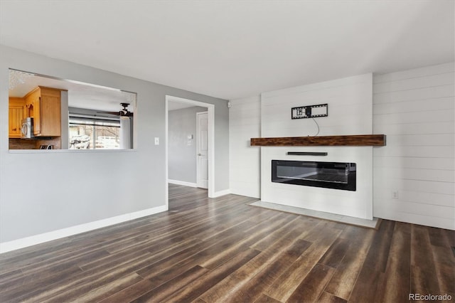 unfurnished living room featuring dark wood-type flooring