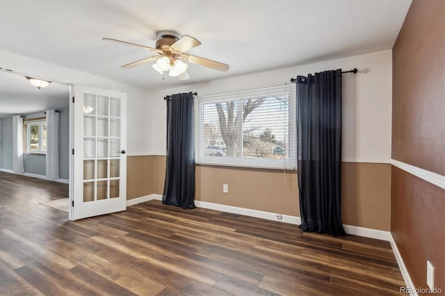 spare room featuring dark hardwood / wood-style floors, a healthy amount of sunlight, and ceiling fan