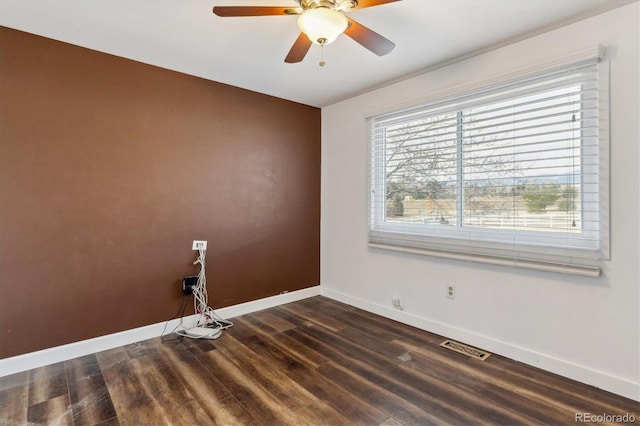 unfurnished room featuring ceiling fan and dark wood-type flooring