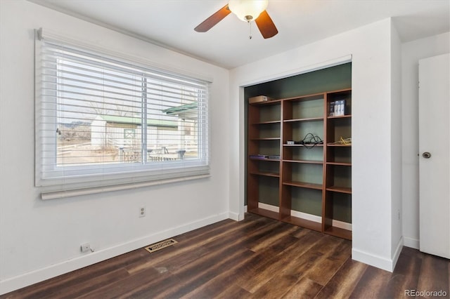 unfurnished room featuring dark hardwood / wood-style floors and ceiling fan