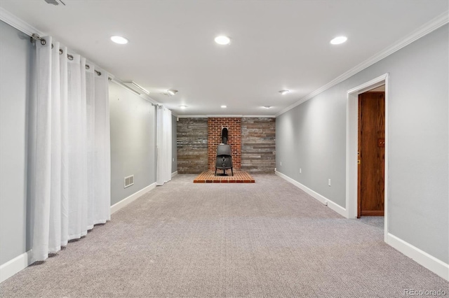 basement featuring a wood stove, light carpet, and ornamental molding