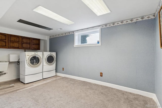 washroom featuring light colored carpet, cabinets, and independent washer and dryer