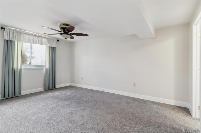 spare room featuring carpet floors and ceiling fan