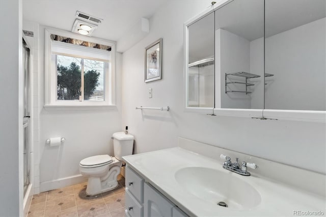 bathroom with vanity, toilet, and walk in shower