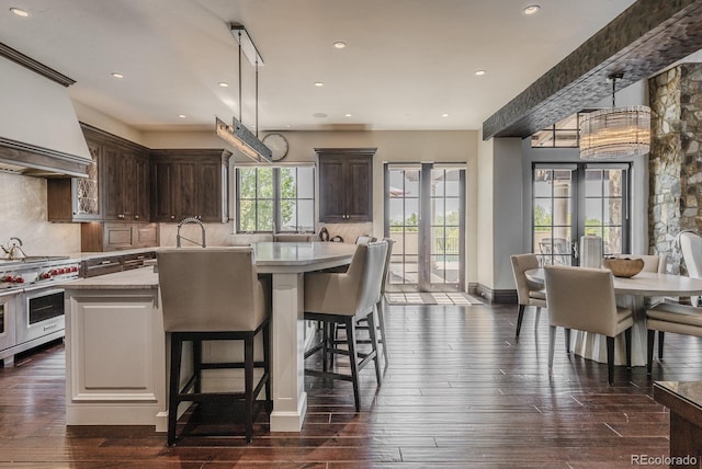 1820 Mallard Dr, Broomfield, CO 80020 - kitchen featuring double oven range, decorative backsplash, dark brown cabinetry, recessed lighting, and dark wood finished floors