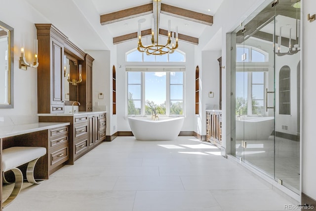 1820 Mallard Dr, Broomfield, CO 80020 - full bathroom with a chandelier, vanity, beam ceiling, a freestanding tub, and baseboards