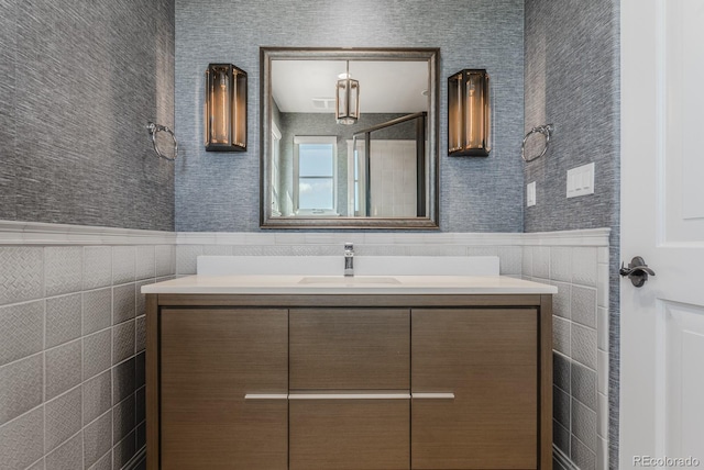 1820 Mallard Dr, Broomfield, CO 80020 - bathroom featuring vanity, a wainscoted wall, and tile walls
