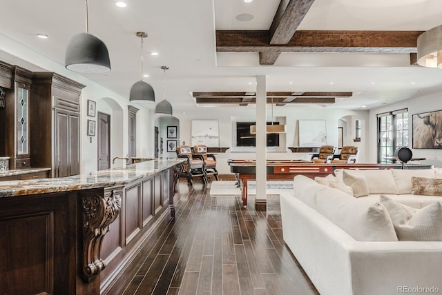 1820 Mallard Dr, Broomfield, CO 80020 - living area featuring coffered ceiling, arched walkways, beam ceiling, dark wood-style floors, and recessed lighting