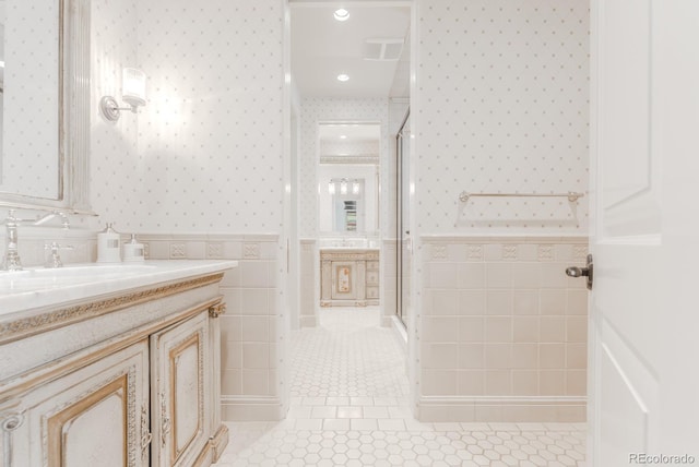 1820 Mallard Dr, Broomfield, CO 80020 - bathroom featuring wallpapered walls, tile walls, tile patterned floors, a stall shower, and vanity