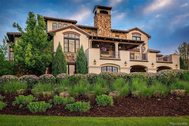 1820 Mallard Dr, Broomfield, CO 80020 - back of house with a balcony, stucco siding, a chimney, and a tile roof