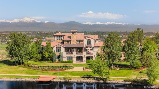 1820 Mallard Dr, Broomfield, CO 80020 - back of house featuring a water and mountain view, a balcony, stucco siding, and a yard