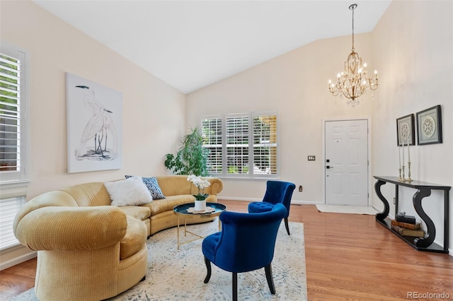 7638 S Hudson Way, Centennial, CO 80122 - living area featuring light wood-style floors, a chandelier, high vaulted ceiling, and baseboards