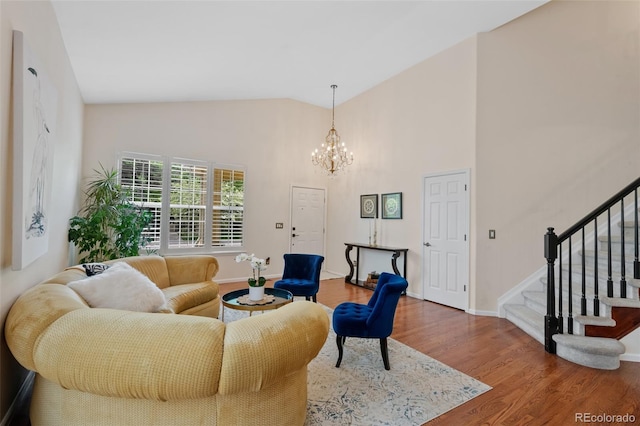 7638 S Hudson Way, Centennial, CO 80122 - living area with stairway, a chandelier, wood finished floors, baseboards, and high vaulted ceiling