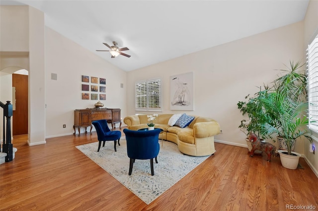 7638 S Hudson Way, Centennial, CO 80122 - living room with ceiling fan, arched walkways, wood finished floors, baseboards, and lofted ceiling