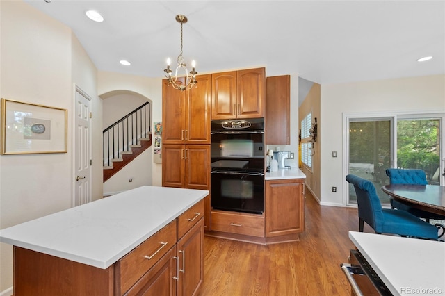 7638 S Hudson Way, Centennial, CO 80122 - kitchen featuring wood finished floors, light countertops, a chandelier, brown cabinetry, and recessed lighting