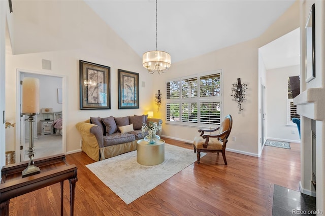7638 S Hudson Way, Centennial, CO 80122 - living room featuring wood finished floors, a chandelier, baseboards, and lofted ceiling