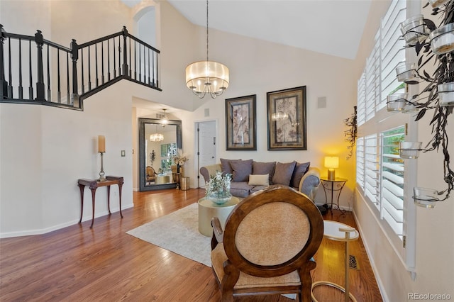 7638 S Hudson Way, Centennial, CO 80122 - living room with high vaulted ceiling, a chandelier, wood finished floors, and baseboards