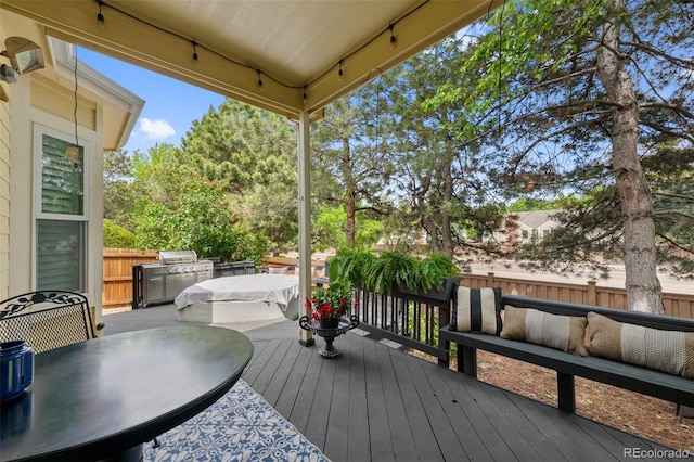 7638 S Hudson Way, Centennial, CO 80122 - wooden deck with outdoor dining area and a grill