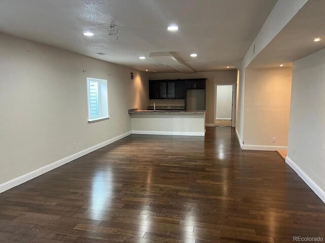 22822 E Union Cir, Aurora, CO 80015 - unfurnished living room with dark wood-style floors, recessed lighting, and baseboards