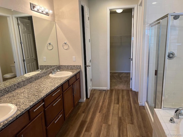 22822 E Union Cir, Aurora, CO 80015 - full bath featuring a shower stall, wood finished floors, and double vanity