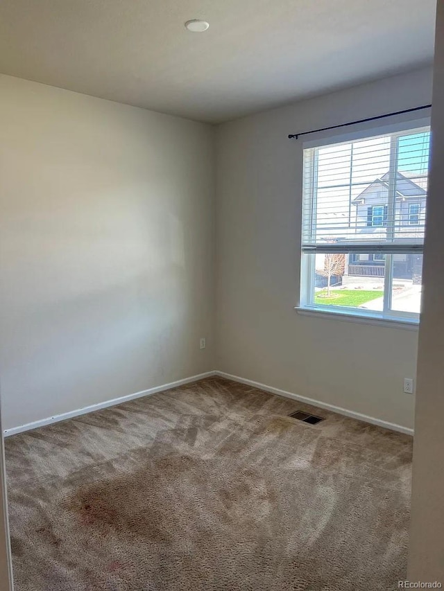 22822 E Union Cir, Aurora, CO 80015 - unfurnished room featuring healthy amount of natural light, carpet, and baseboards