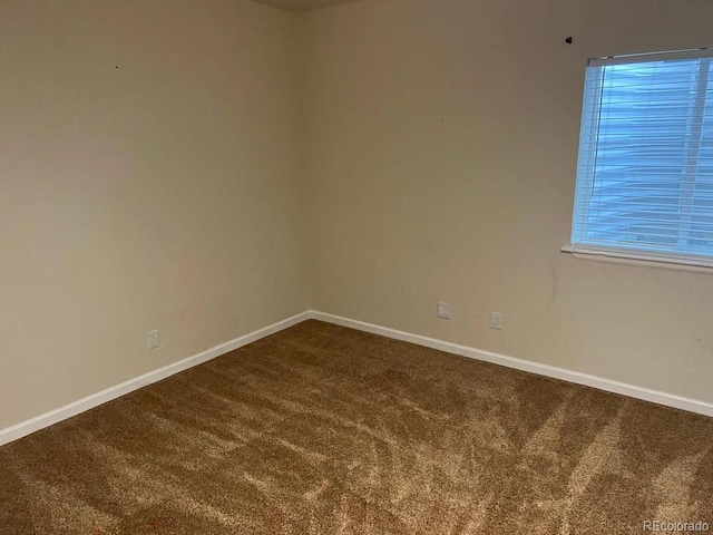 22822 E Union Cir, Aurora, CO 80015 - unfurnished room with dark carpet and baseboards