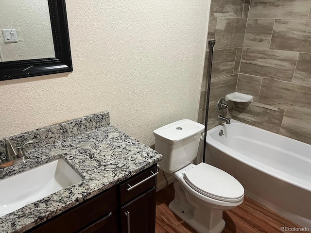 22822 E Union Cir, Aurora, CO 80015 - bathroom featuring a textured wall, wood finished floors, vanity, toilet, and shower / bath combination