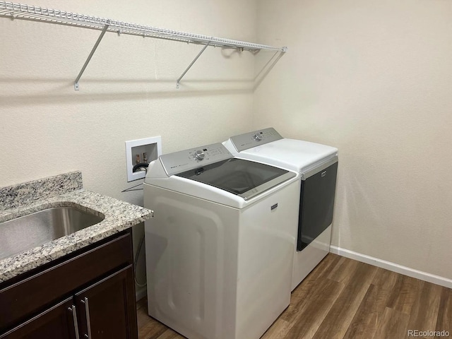 22822 E Union Cir, Aurora, CO 80015 - laundry room with washer and clothes dryer, cabinet space, dark wood finished floors, and baseboards