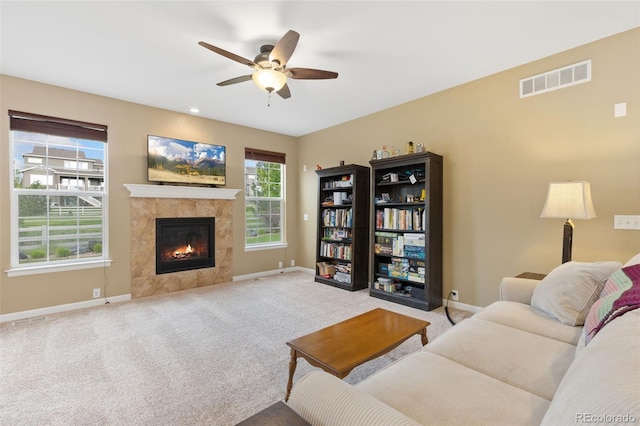 2647 Gray Wolf Loop, Broomfield, CO 80023 - living room featuring a ceiling fan, a tile fireplace, and carpet floors