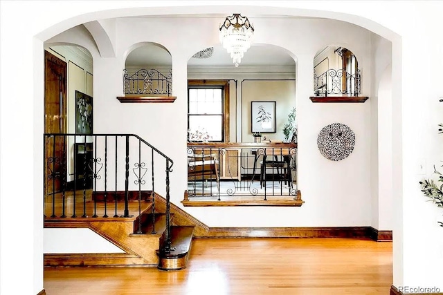 entryway with stairway, baseboards, and wood finished floors