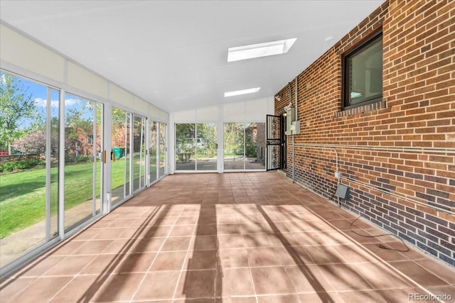 unfurnished sunroom featuring a skylight