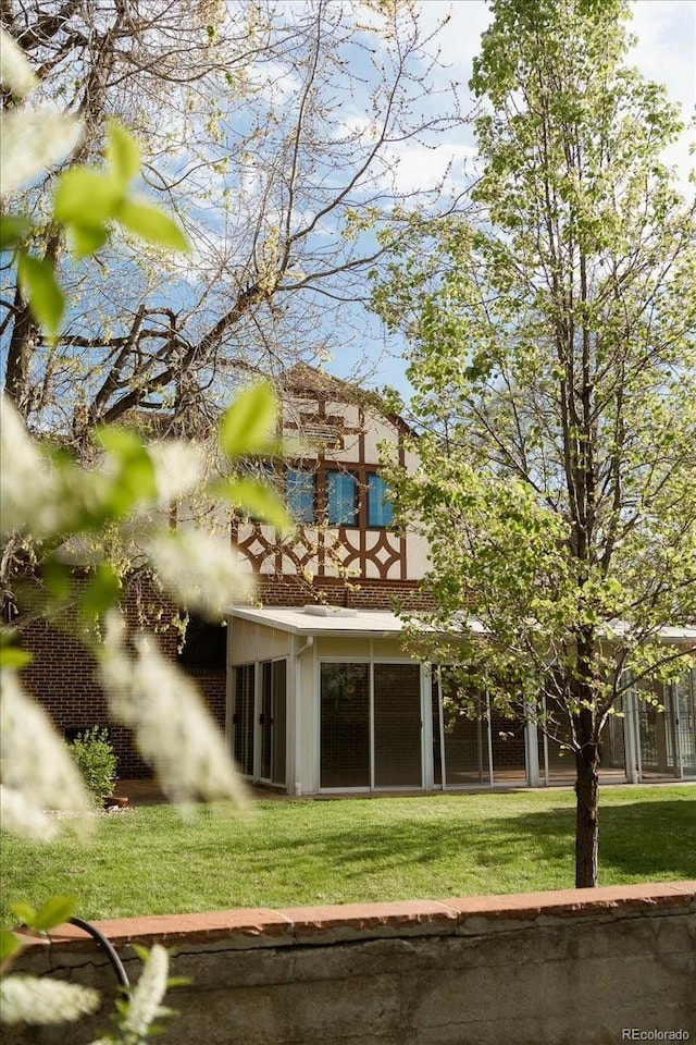 rear view of house featuring a lawn