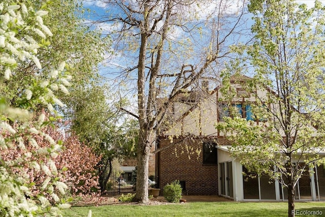 exterior space with a yard and brick siding