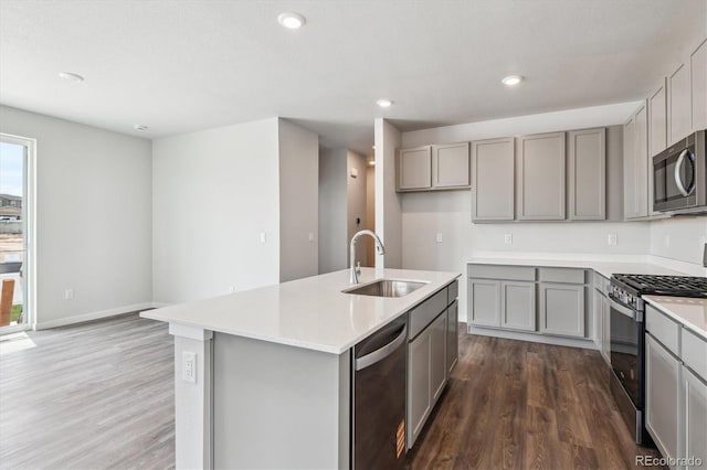 14131 Deertrack Ln, Parker, CO 80134 - kitchen featuring a sink, appliances with stainless steel finishes, gray cabinets, dark wood-style floors, and recessed lighting