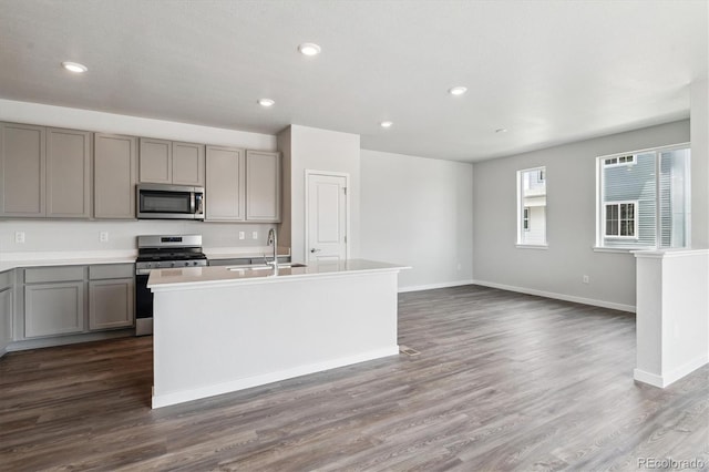 14131 Deertrack Ln, Parker, CO 80134 - kitchen with stainless steel appliances, gray cabinets, a sink, baseboards, and recessed lighting