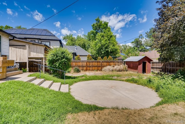 view of yard featuring a shed and a patio