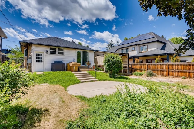 back of property with a patio