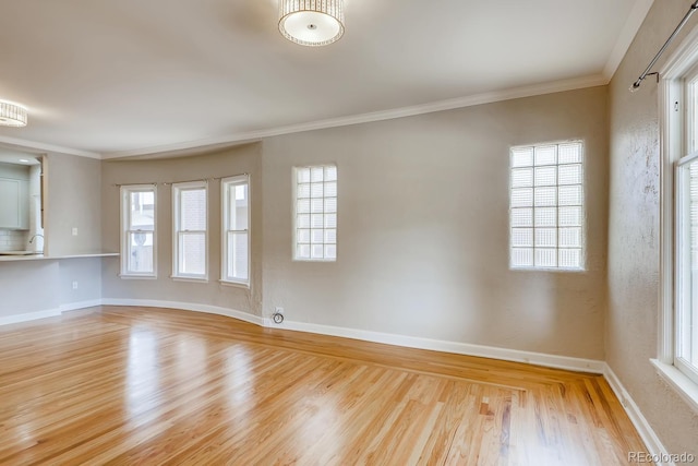 unfurnished room with light wood-type flooring, plenty of natural light, and ornamental molding