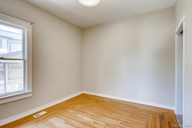 unfurnished room with hardwood / wood-style flooring